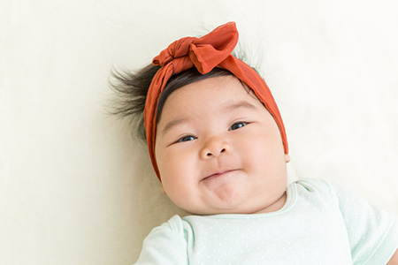 Asian baby smiling at camera