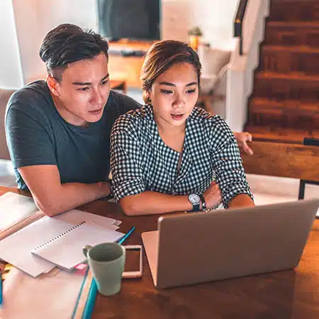 couple hoping to adopt looking at computer