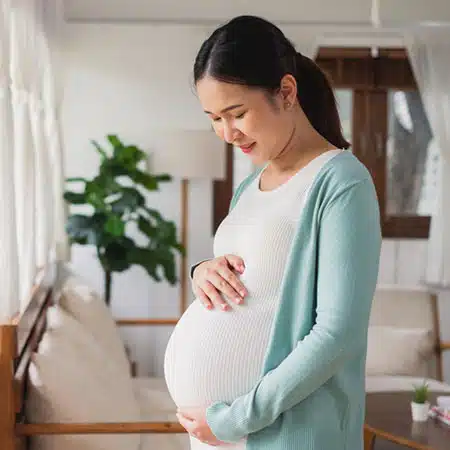pregnant woman holding her belly